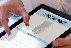 Patient reviewing dental insurance form on tablet