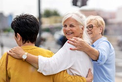 Group of women smiling while walking together outside