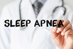 Dentist writing sleep apnea with marker