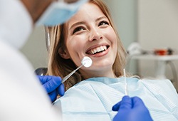 a woman receiving a dental exam from a dentist