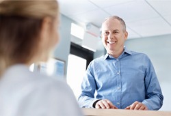 Smiling patient visiting the dental office 