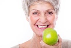 Older woman holding an apple