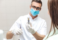 dentist speaking to a patient about dental implants