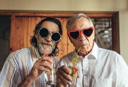two friends drinking from swirly straws