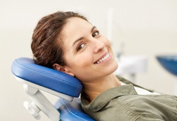 Woman in dentist’s chair smiling