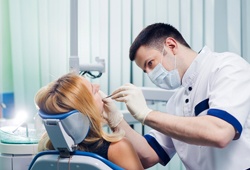 Woman Receiving oral cancer screening exam