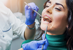 Woman receiving oral cancer screening