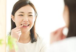 Woman pointing to teeth