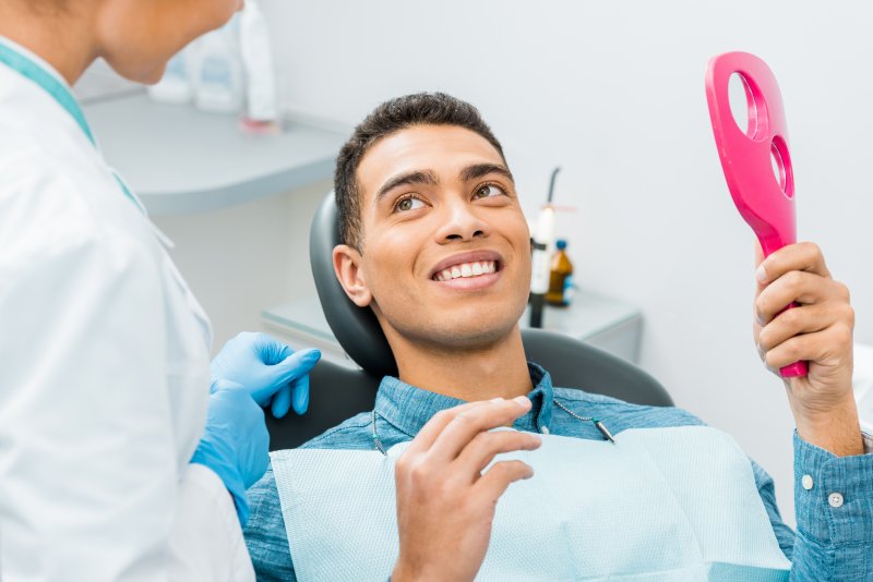 young man smiling in dentist chair