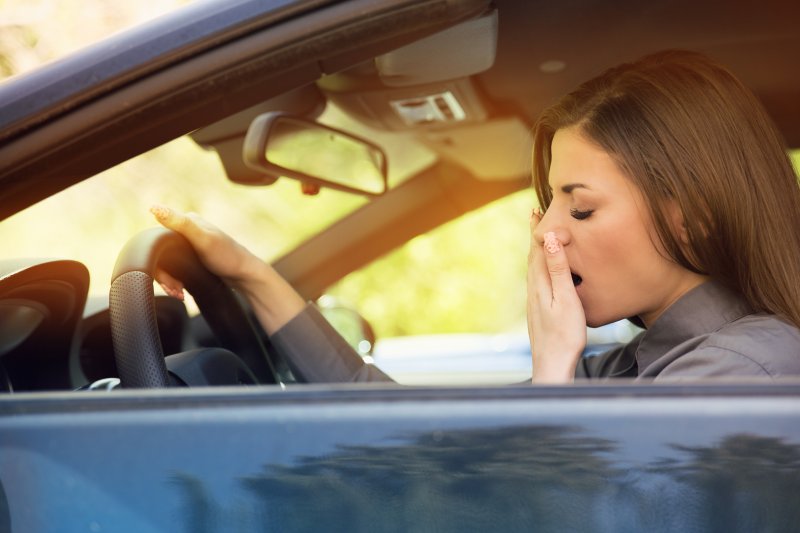 woman struggling to stay awake in car