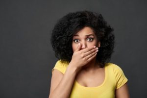 Concerned woman covering her mouth because of bad oral health habits
