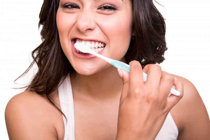 woman brushing teeth anticipating visit to dentist in Stephens City