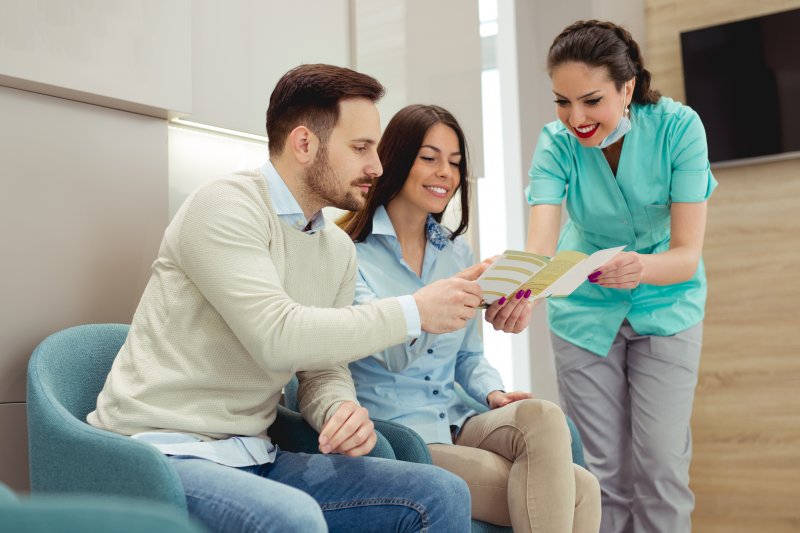 Dentist talking to patients about dental insurance