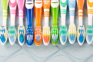 A colorful row of different toothbrushes lined up