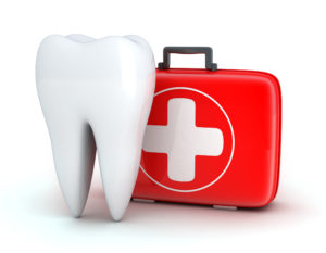 Giant tooth next to red dental emergency kit