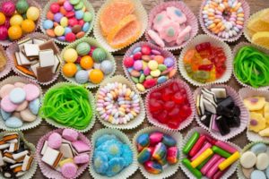 cupcake tins filled with different kinds of candy