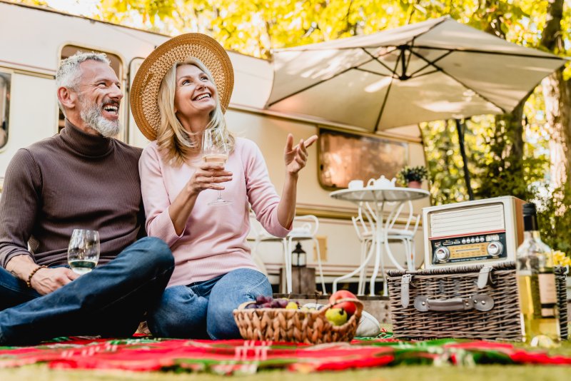 Mature couple talking and smiling during summer picnic