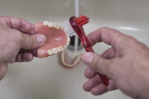 denture cleaning with brush
