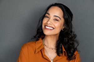 A patient smiling and showing off her healthy teeth