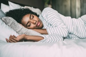 a woman sleeping healthily and happily