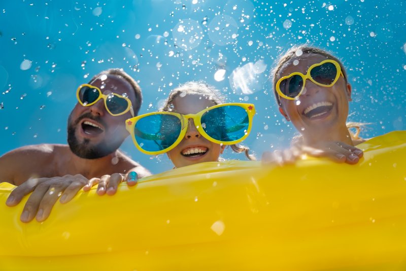 family playing in the water