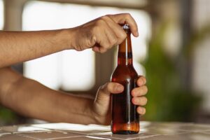 Close up of man opening a beer
