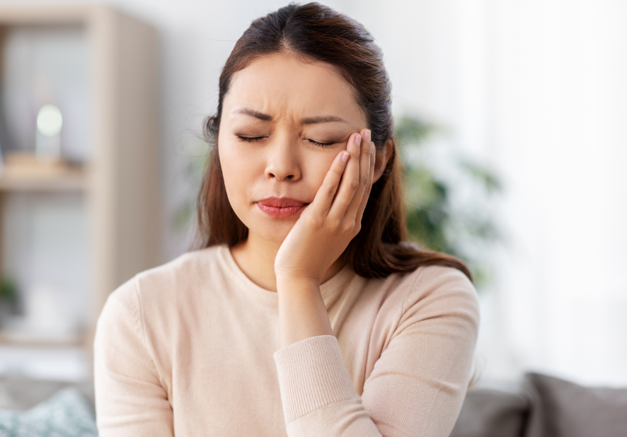 Woman holding jaw in pain